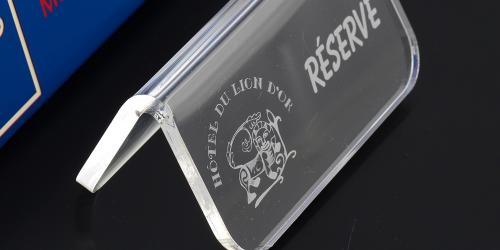 Small signage with a text and logo made with acrylic engraving machine