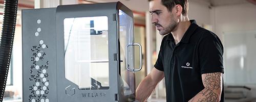 Operator using Gravotech WeLase™ laser engraving machine in a workshop