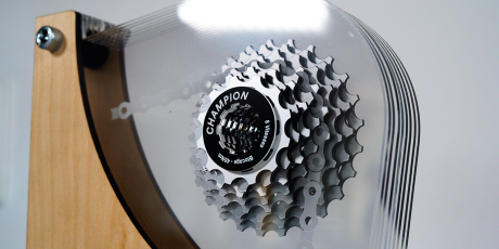 Laser cut acrylic trophy in bike gear shape, layered for a 3D motion effect